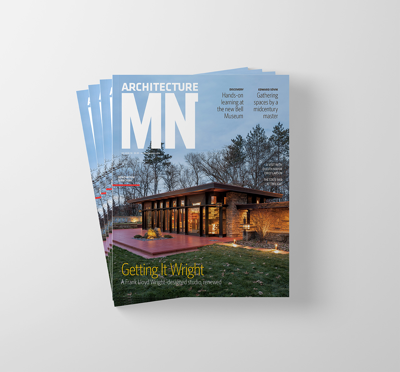A stack of Architecture MN magazines. The cover shows a Frank Lloyd Wright designed home.